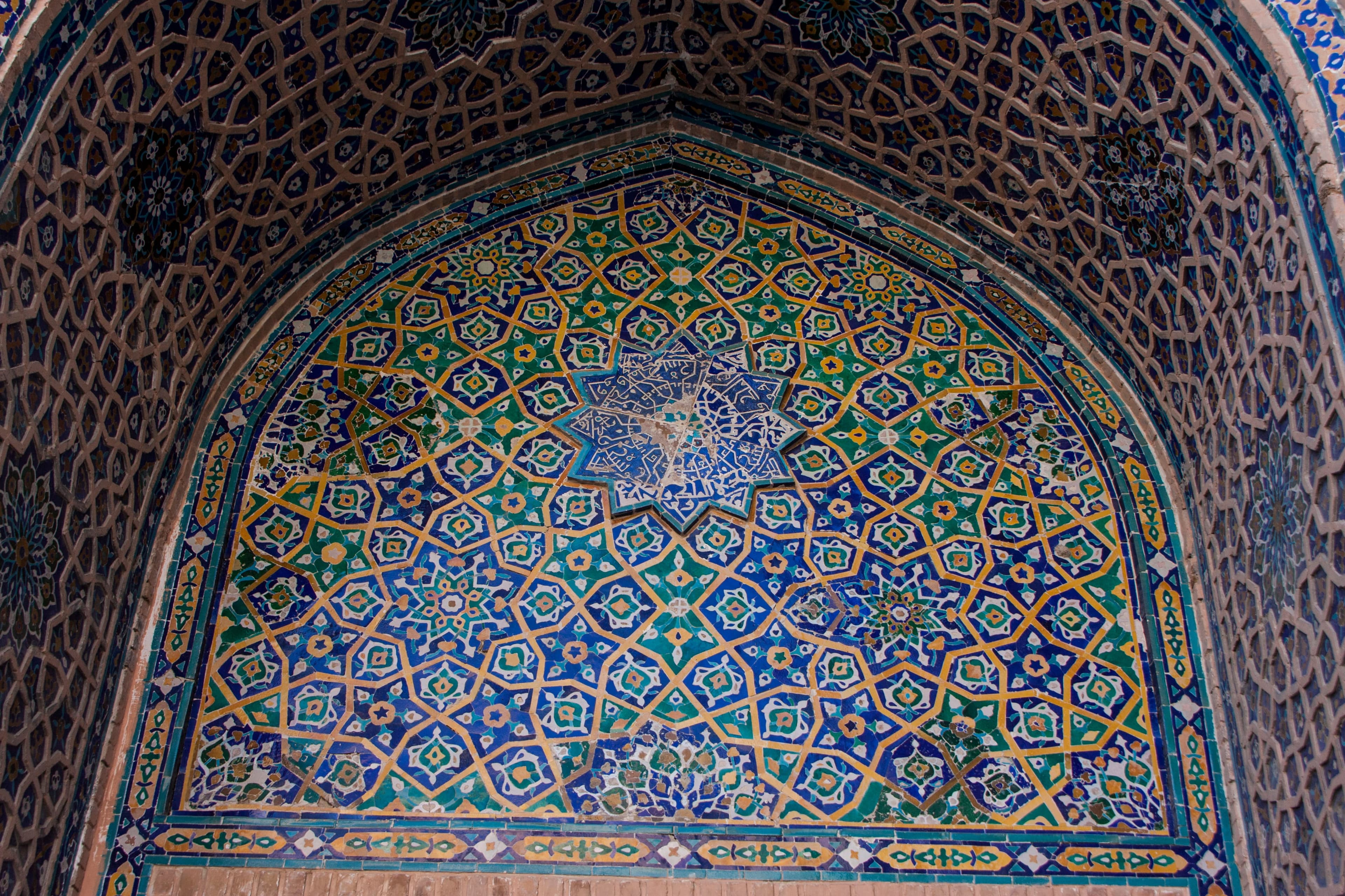 Star mosaic inside the Ulugh Beg portal recess, with interlacing ochre lines, polygons and floral infill